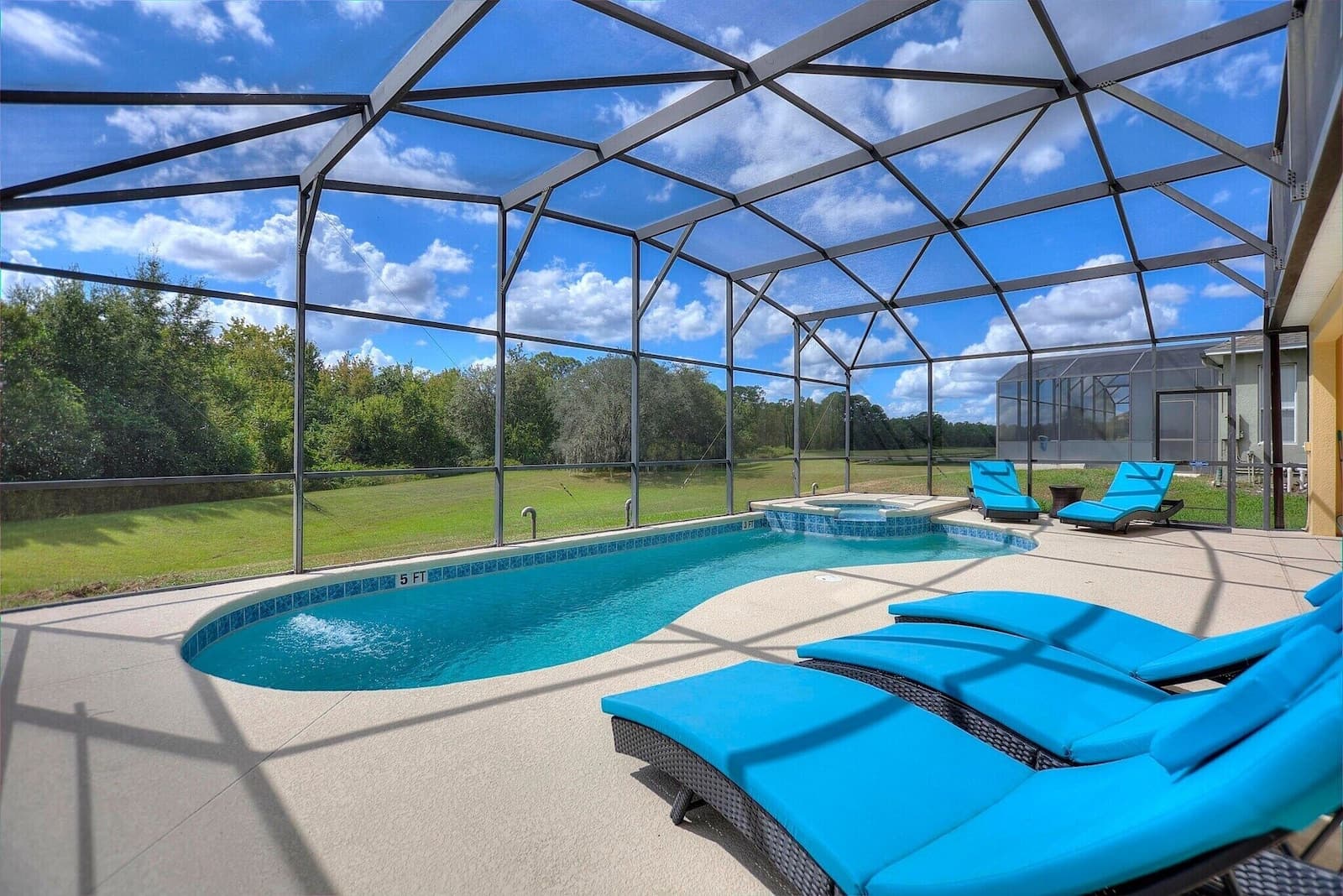 Private screened pool deck with blue loungers