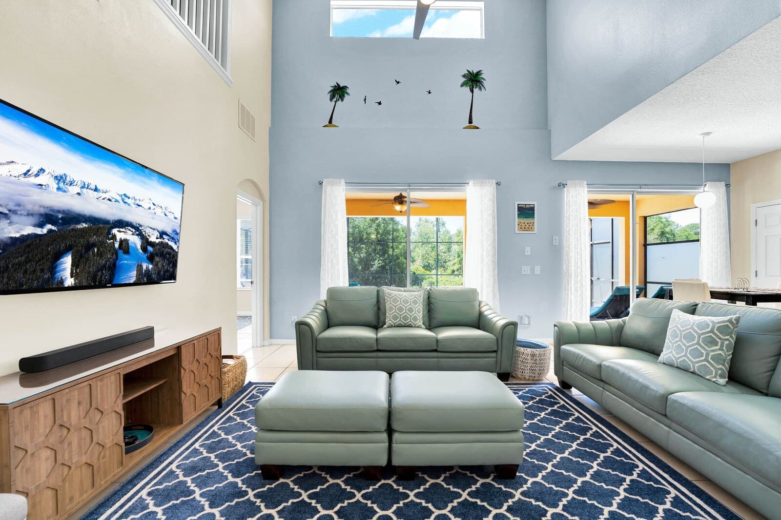 Main living room with grey sofas and a large TV