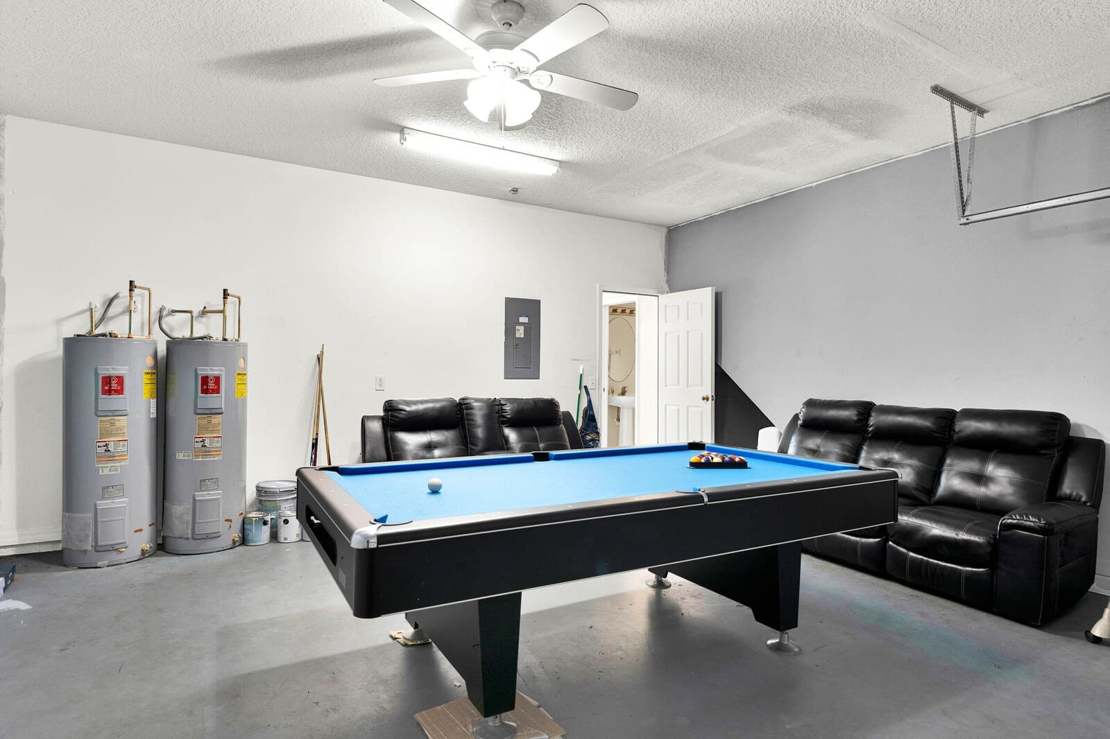 Game room with pool table and leather seating