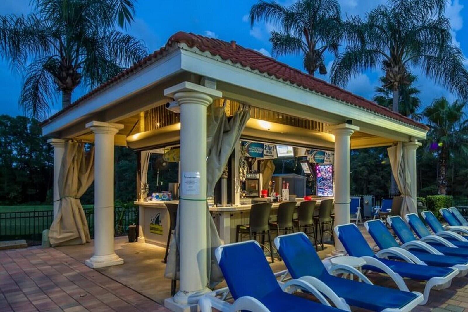 Poolside cabana bar with lounge chairs at the resort clubhouse