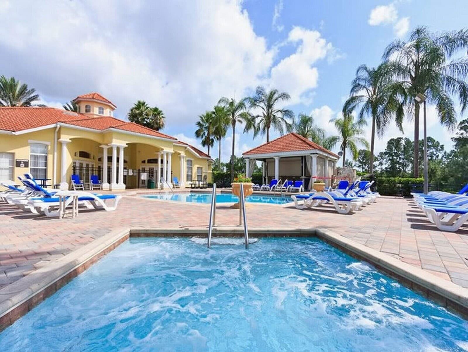 Emerald Island Resort pool with palm trees and clubhouse
