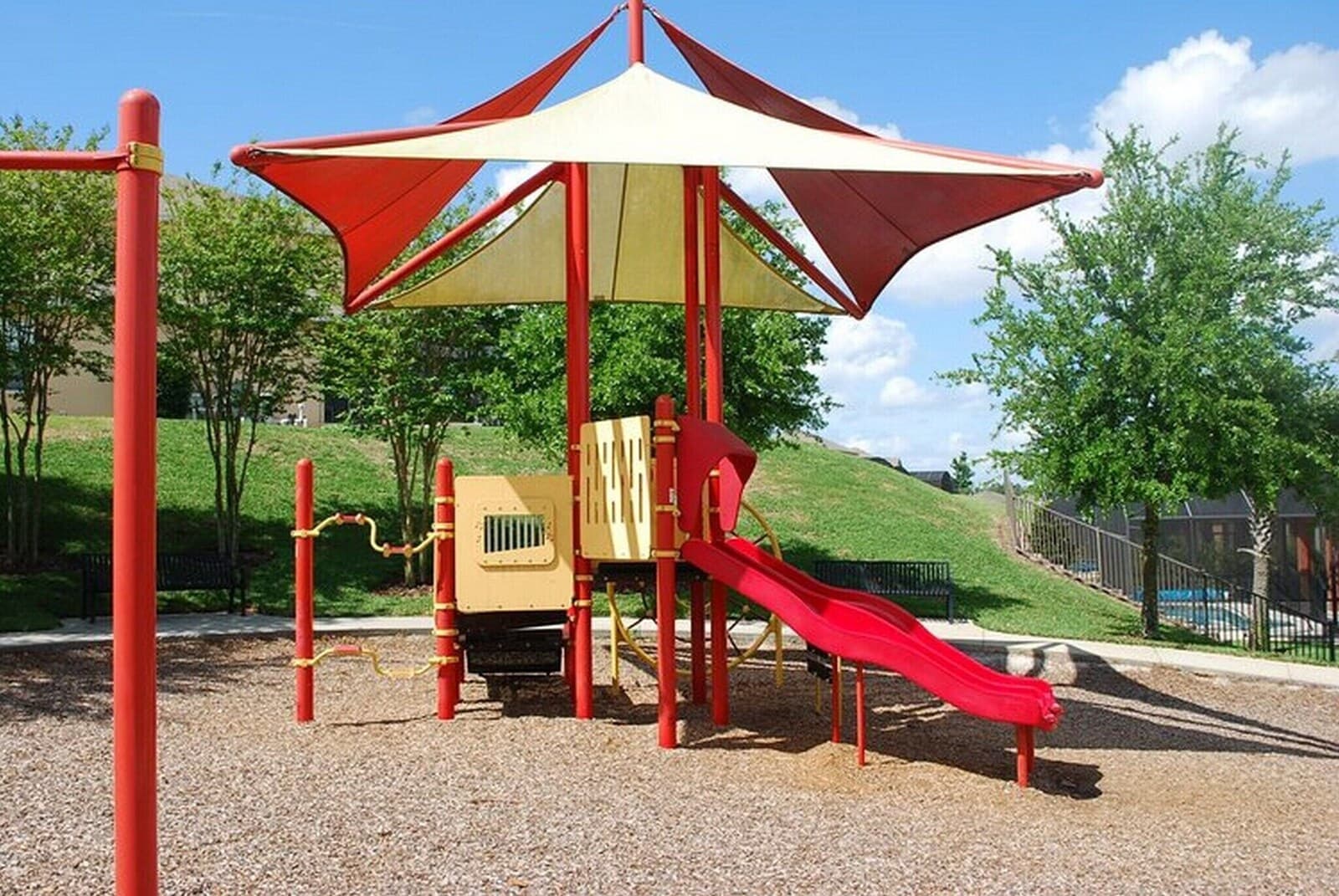 Resort playground with a red slide
